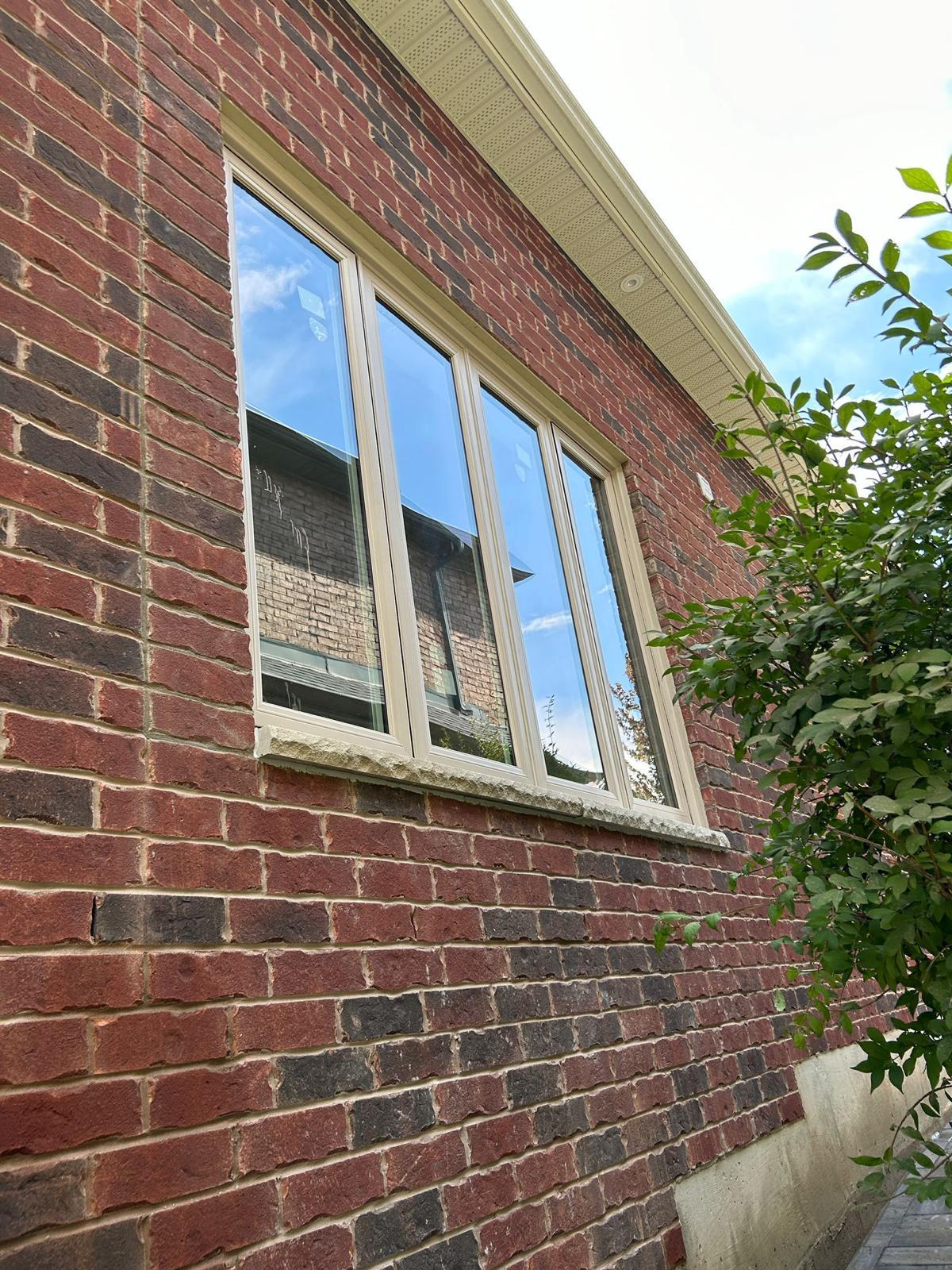 Triple window installation on a brick home
